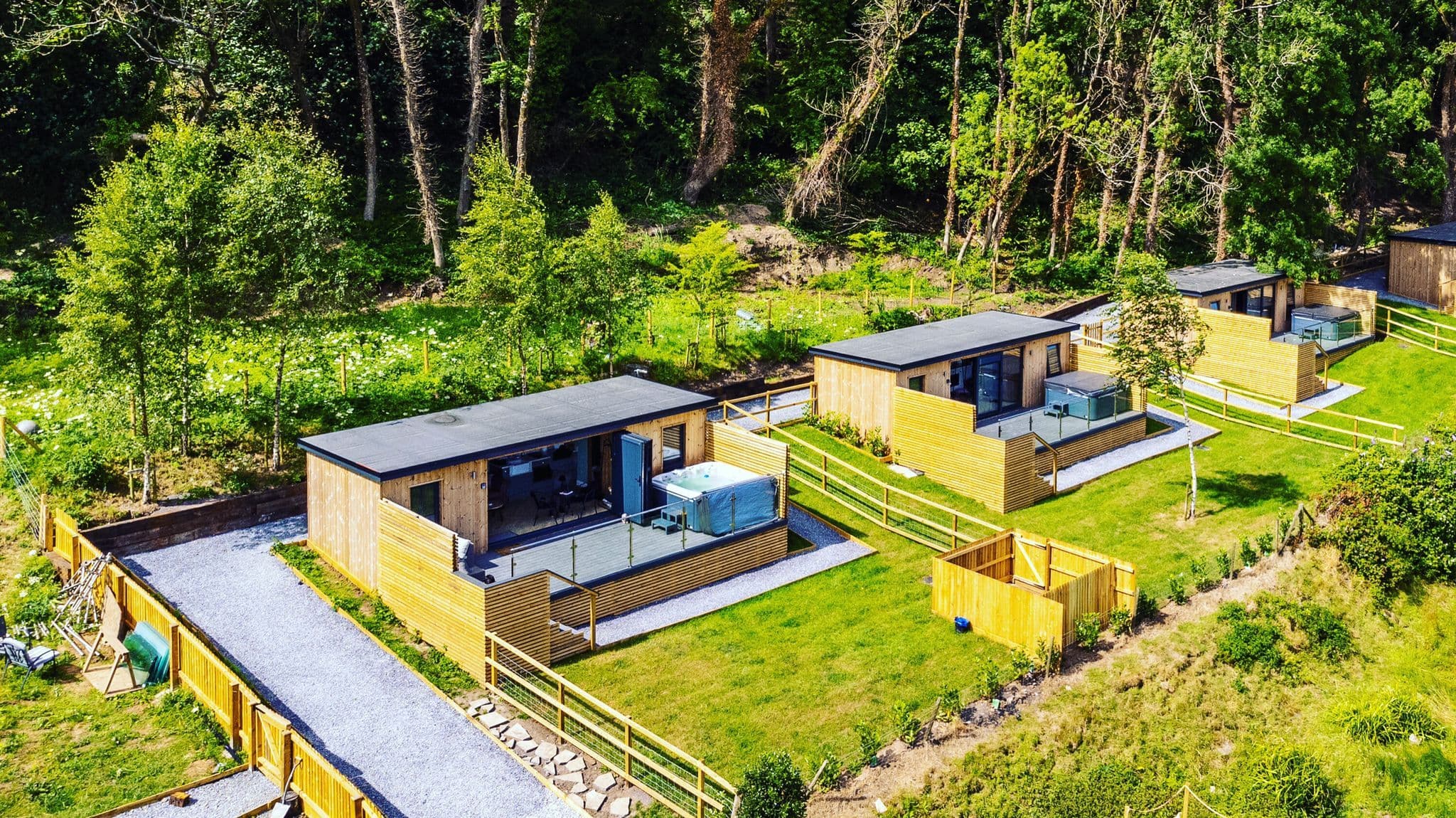 Gower Coast Cabins from above — cabins and hot tubs set in woodland